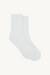 Pair of white socks with 'SET' logo on a beige background 