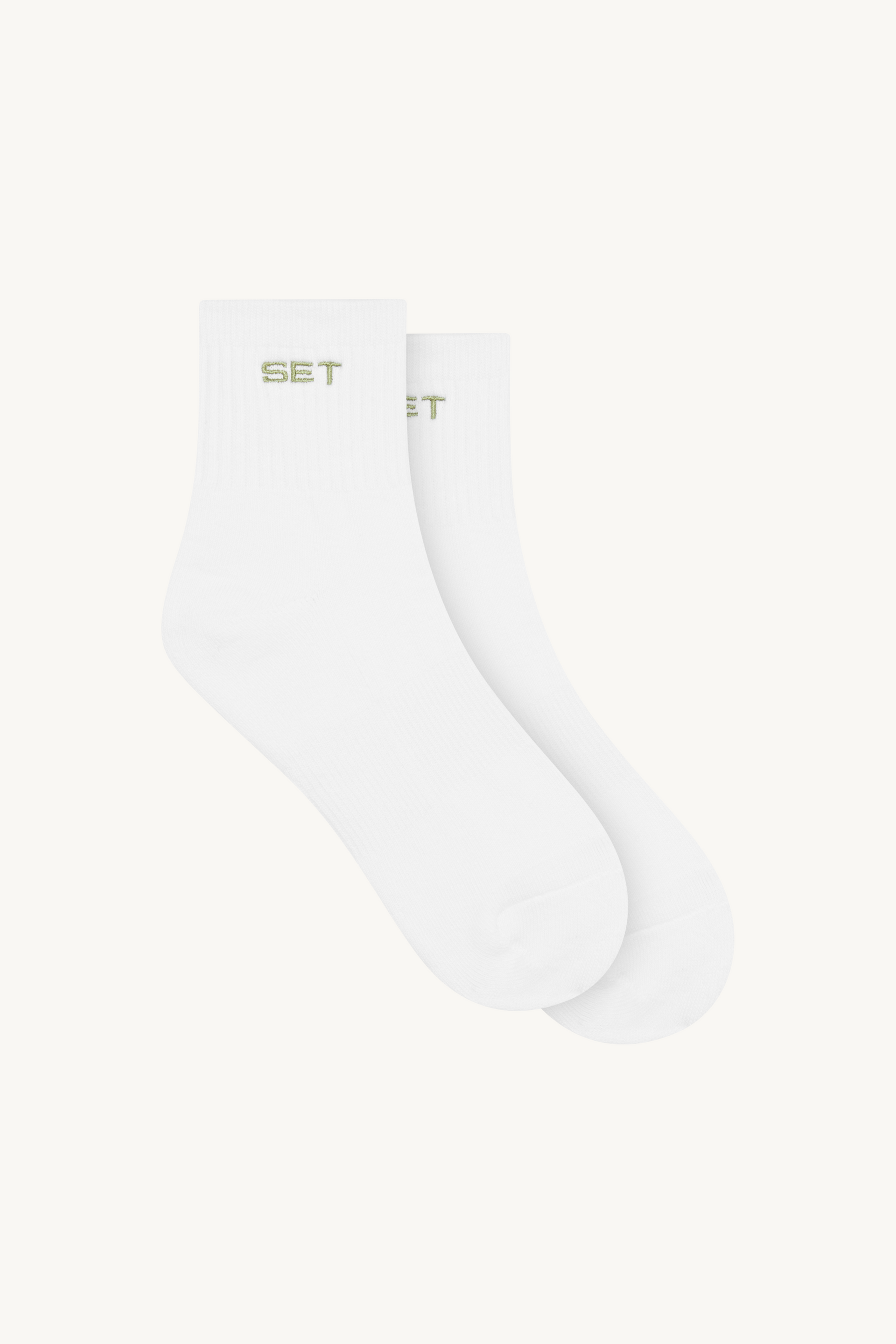White socks with green text on a white background
