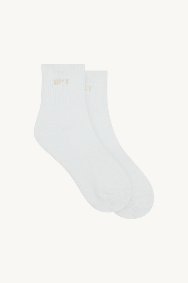 Pair of white socks with 'SET' brand logo 