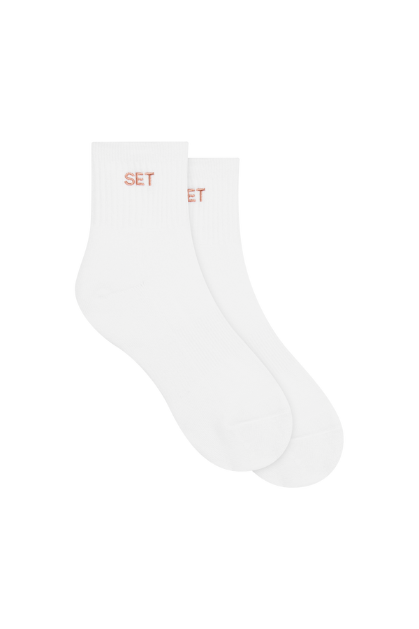 White socks with pink 'SET' logo