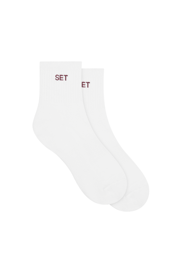 White socks with red 'SET' logo on a white background