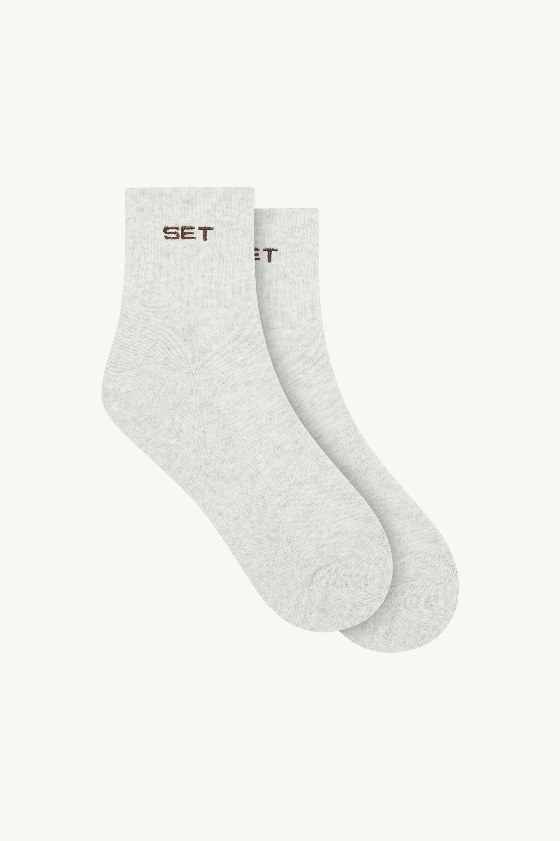 Two white socks with 'SET' branding on a white background