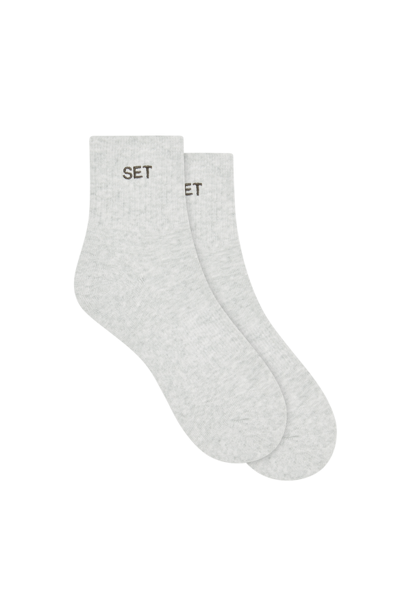 Two pairs of gray socks with grey 'SET' branding on a white background