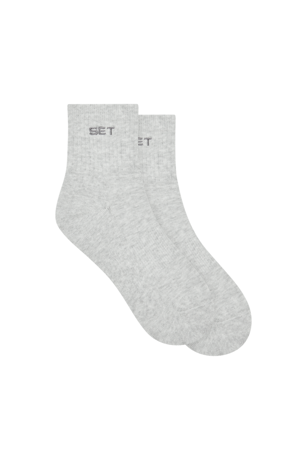 Pair of gray socks with 'SET' branding on a white background