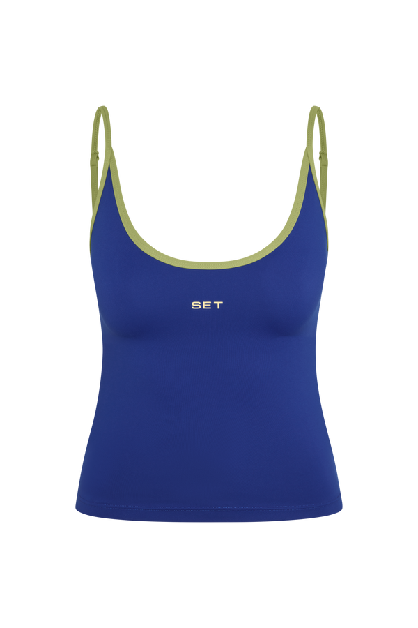 A royal blue athletic tank top with olive green trim along the scoop neckline and thin shoulder straps, featuring the brand name 'SET' printed in white on the chest.