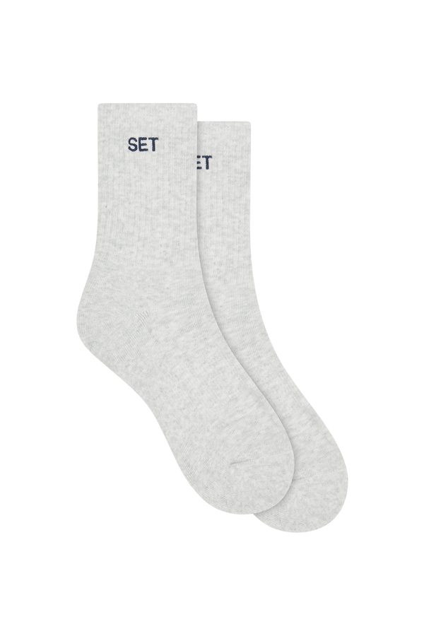 Pair of gray socks with navy 'SET' branding on a white background