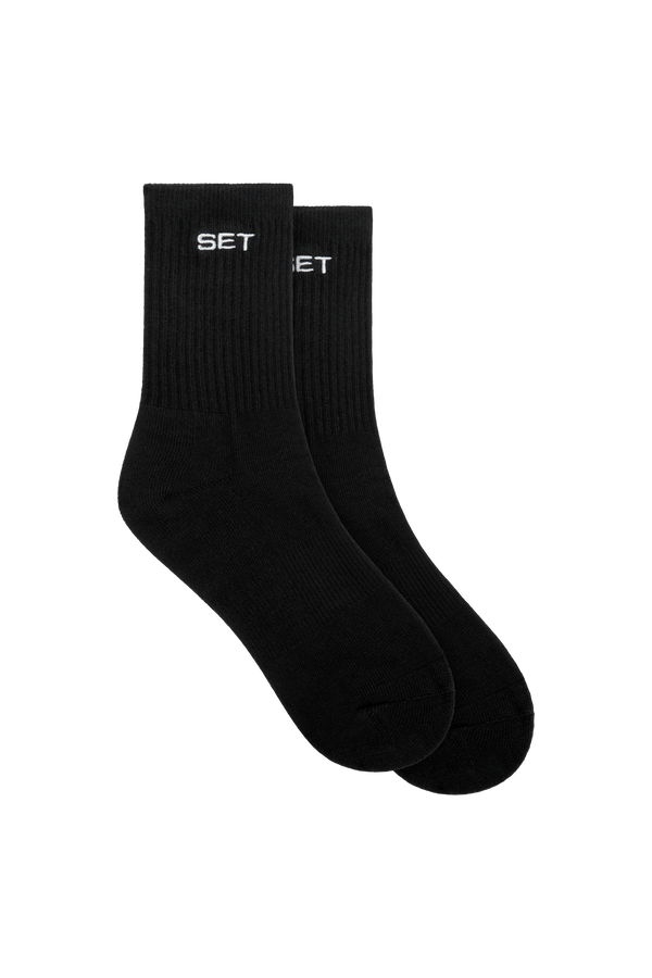 Two black socks with 'SET' branding on a white background