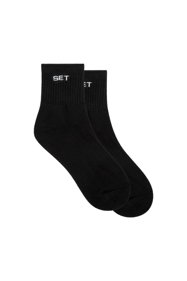 Two black socks with 'SET' branding on a white background