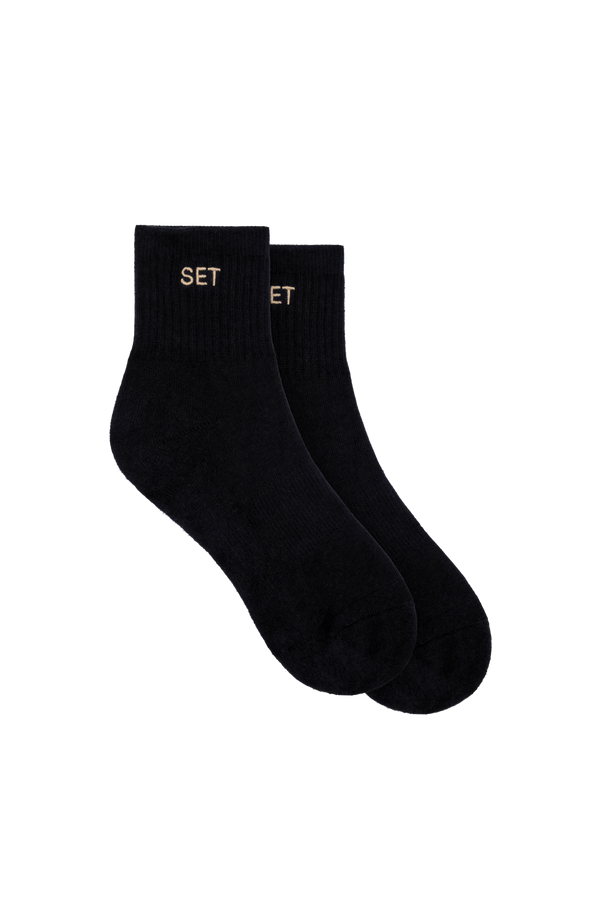 Black socks with tan logo on white background