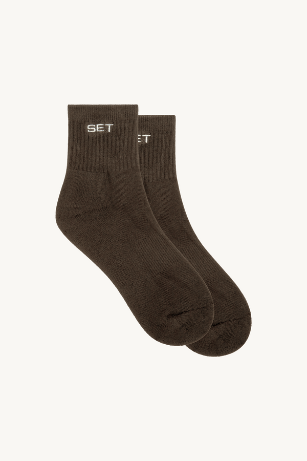 Two brown socks with 'SET' branding on a white background