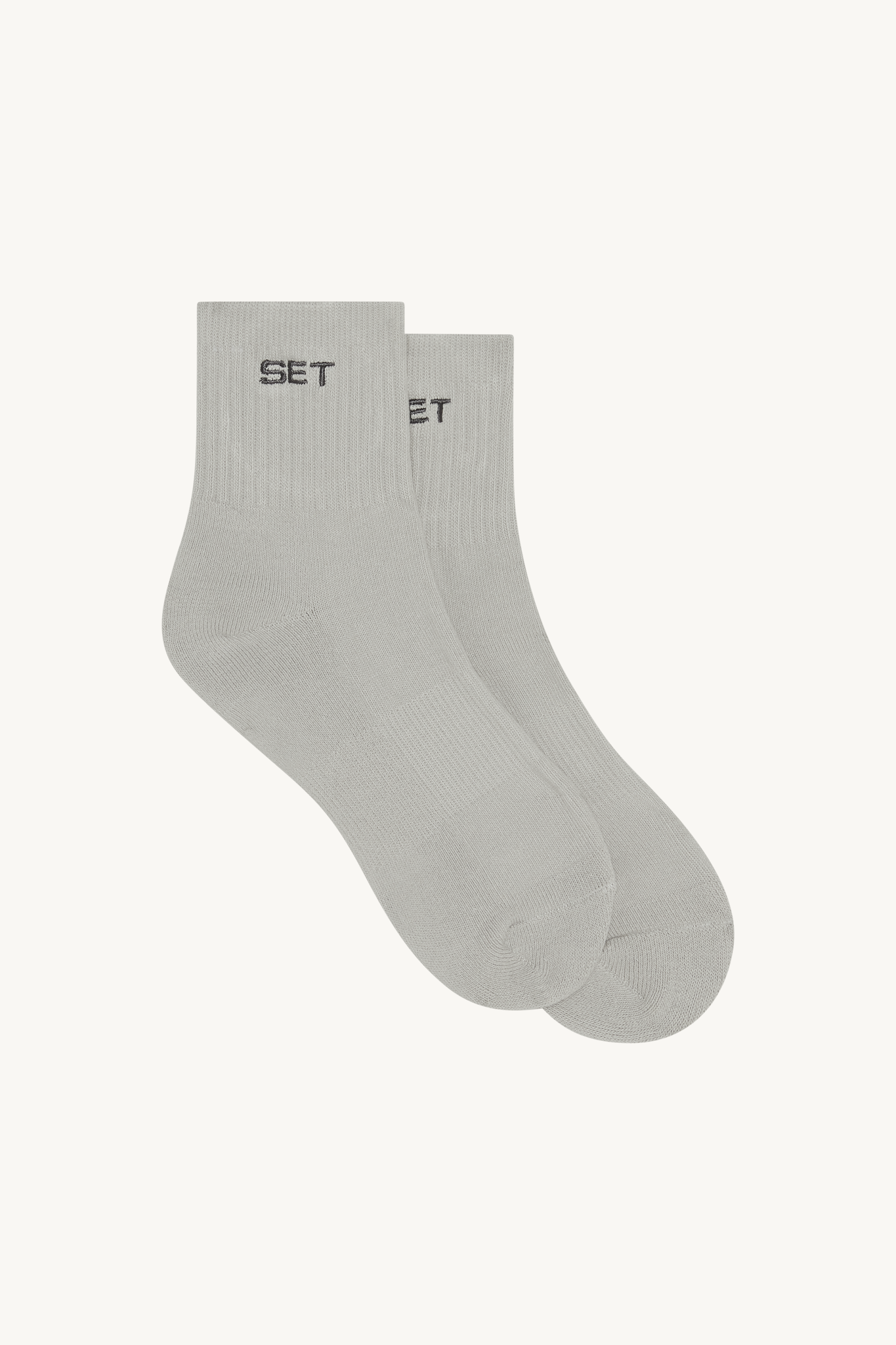 Gray ankle socks with 'SET' brand logo on a beige background 