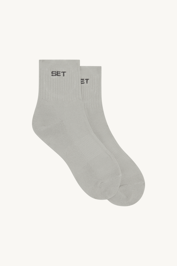 Gray ankle socks with 'SET' brand logo on a beige background 