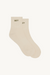 Beige ankle socks on a beige background with 'SET' logo 