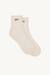 Pair of beige socks with red text on a white background
