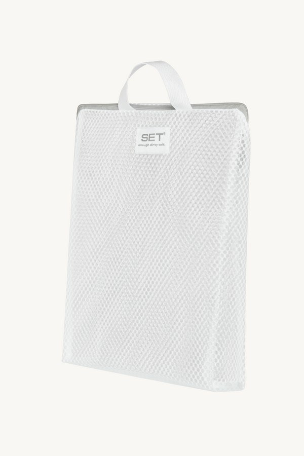 White textured towel on a hanger with 'SET' label against a white background