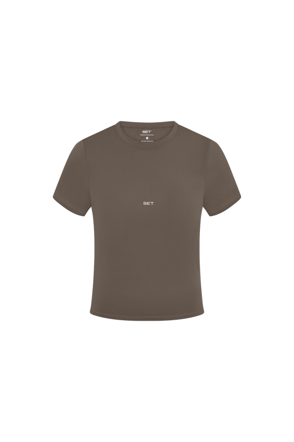 Brown t-shirt with a small white logo on a white background