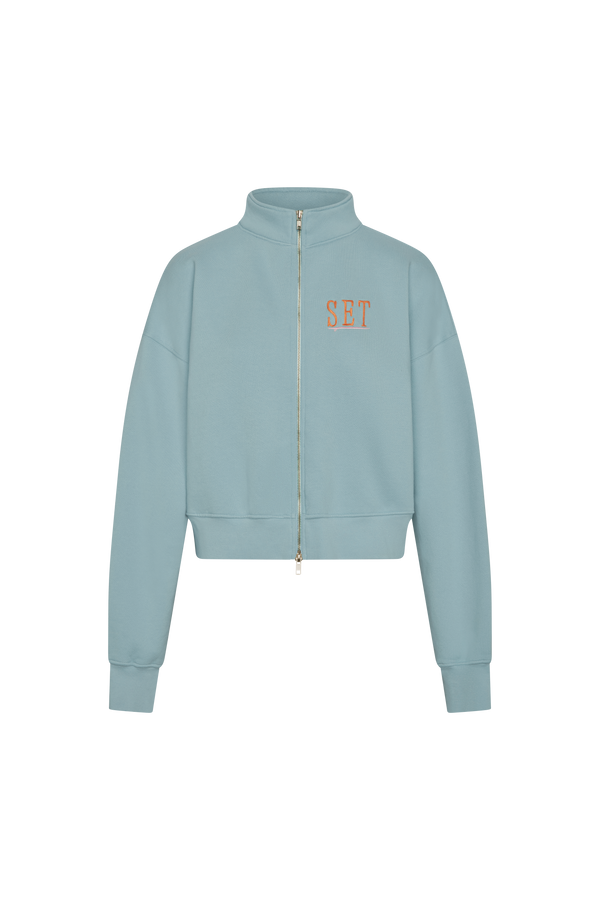 Light blue jacket with a brand logo on a white background