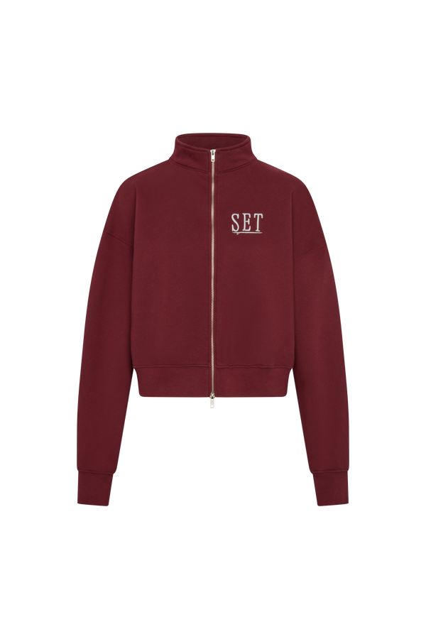 Maroon jacket with 'SET' logo on a white background