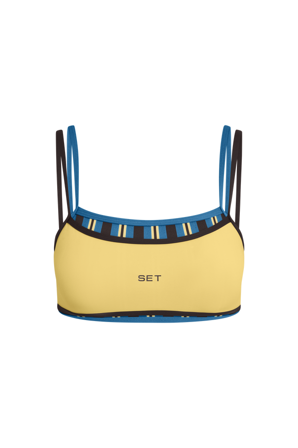 Yellow bikini top with blue and black straps on a white background