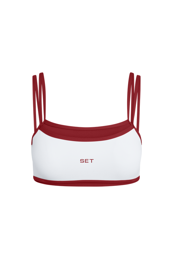 White and red activewear top with 'SET' branding on a white background