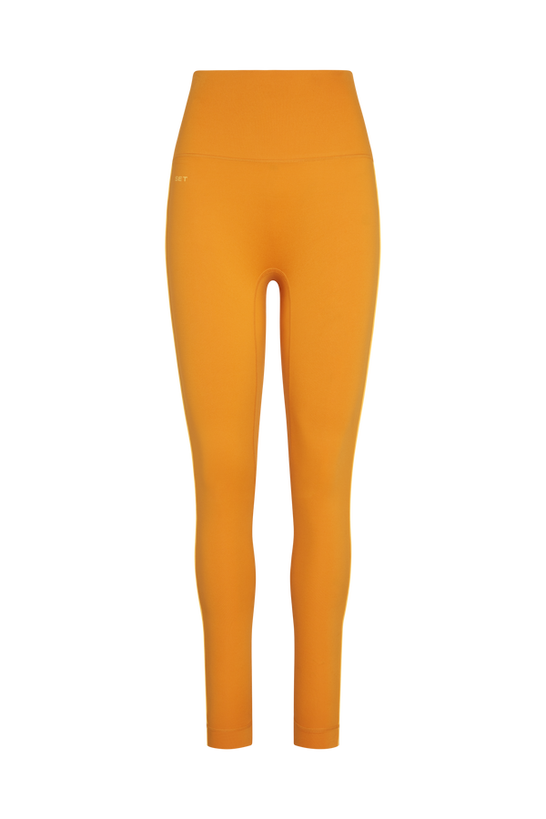 Mustard yellow leggings on a white background
