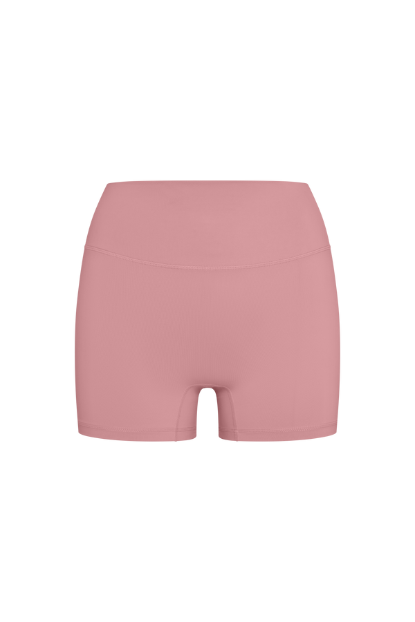 A pair of high-waisted, seamless athletic shorts in a dusty rose pink color, shown from the back on a plain white background.