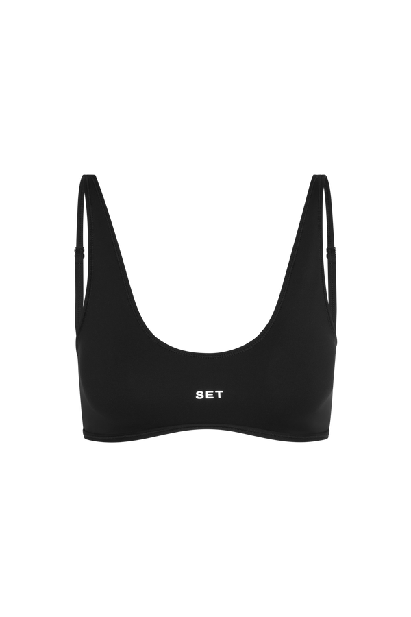 Black sports bra with 'SET' branding on a white background