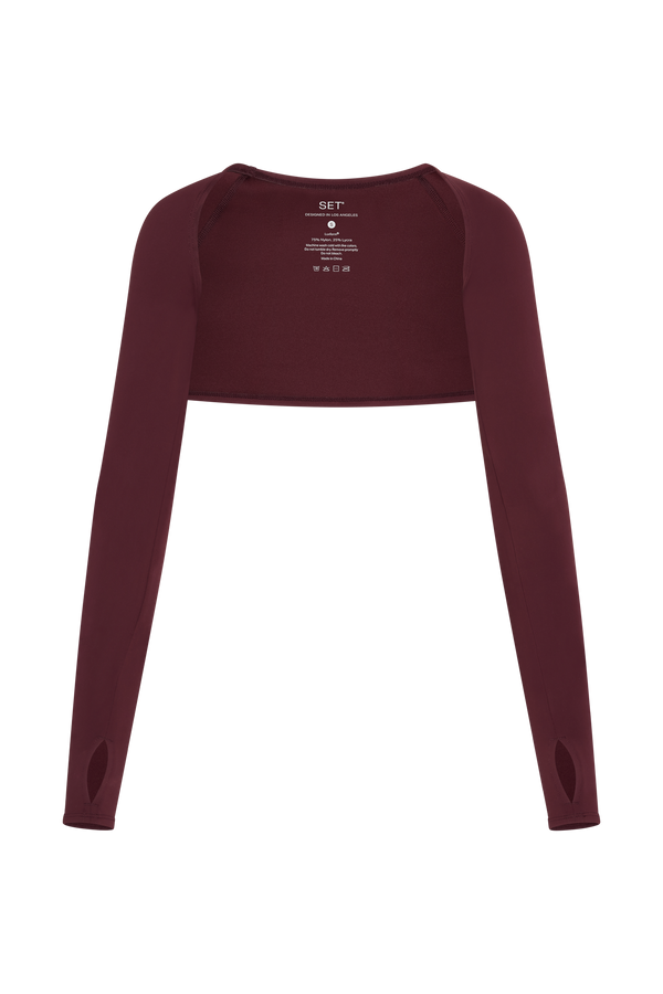 Maroon long-sleeve crop top on a white background