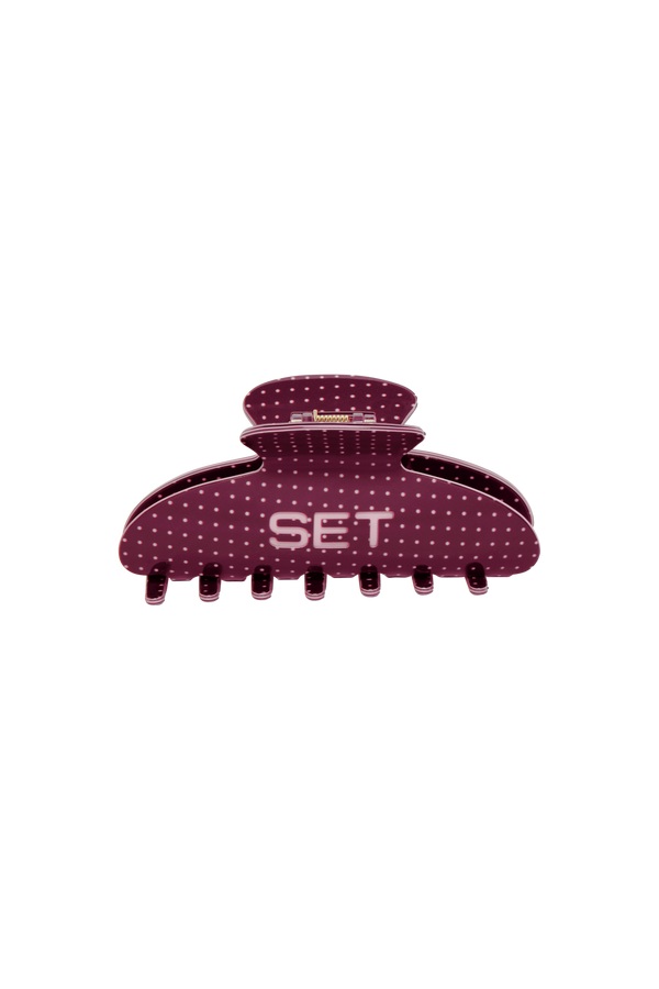 mauve colored hair clip with light pink polka dots and engraved 'SET' logo on a white background.