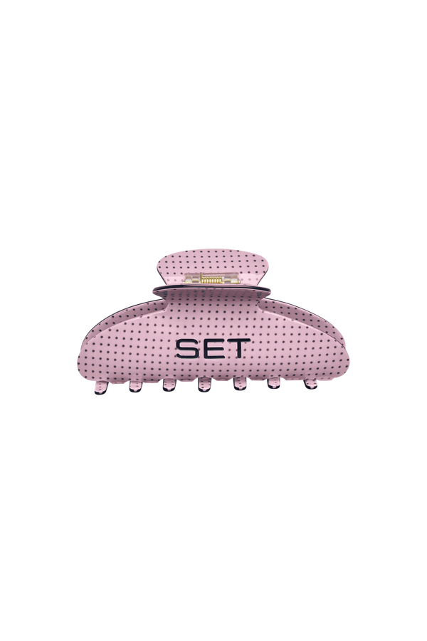 Pink with brown polka dots hair clip with 'SET' branding on a white background