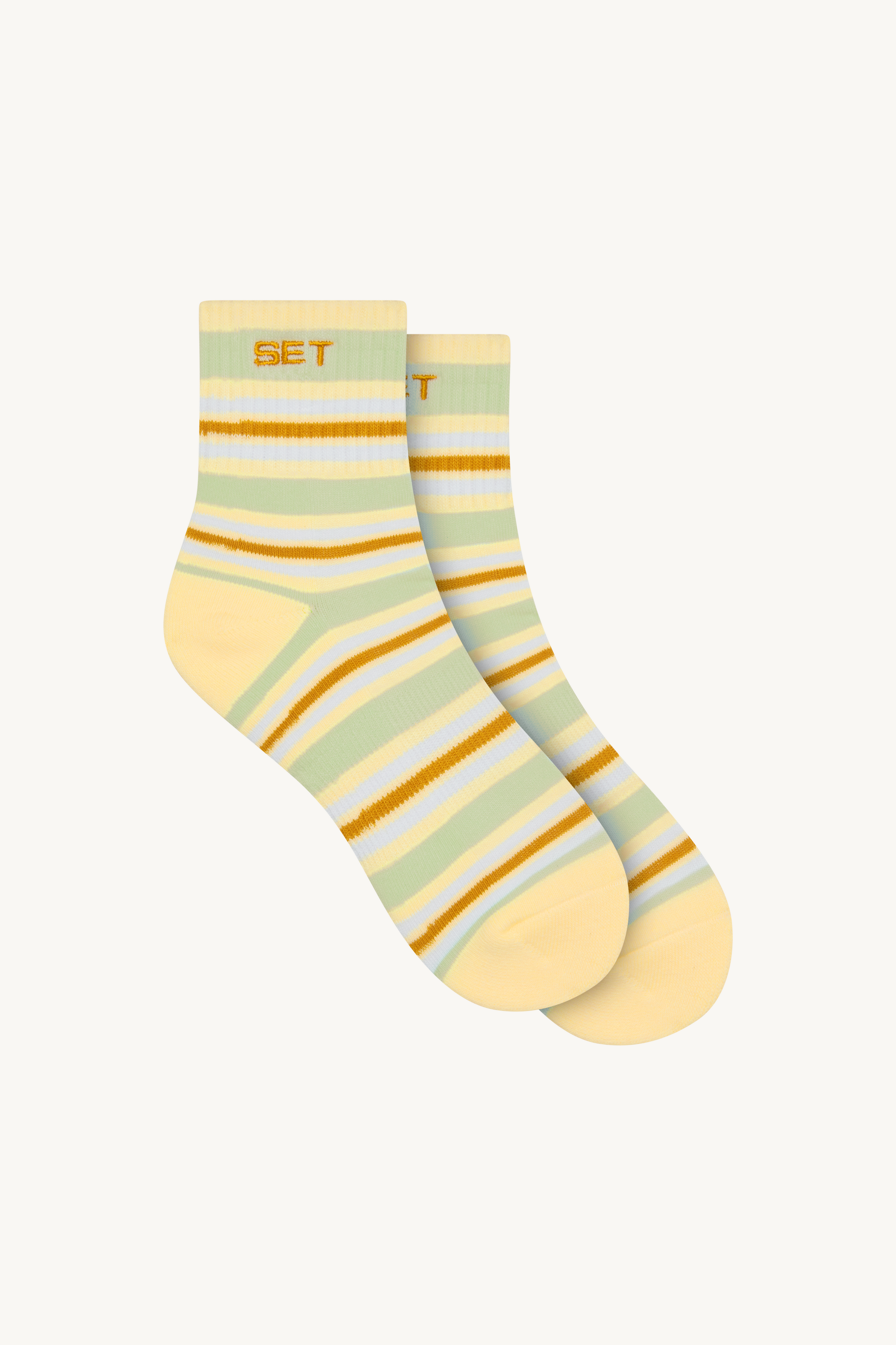 Striped pair of socks on a beige background
