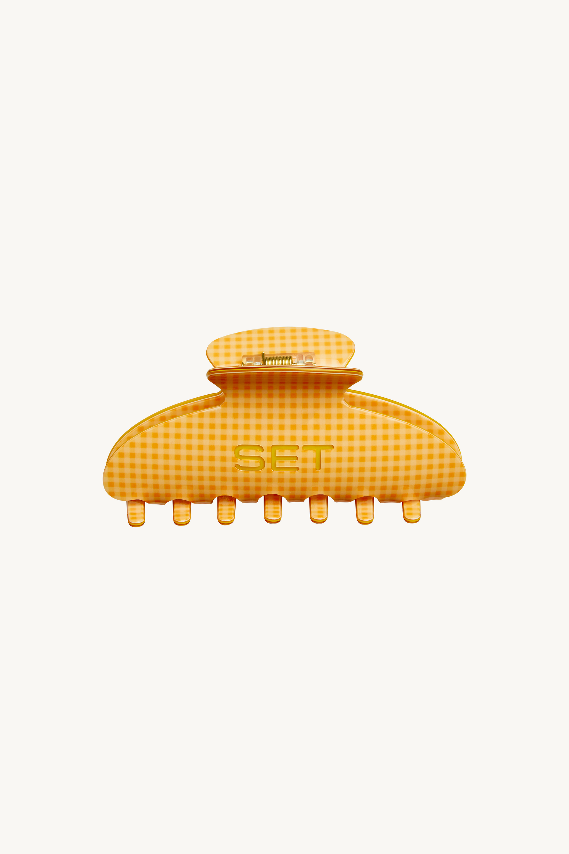 Yellow checkered hair clip on a white background