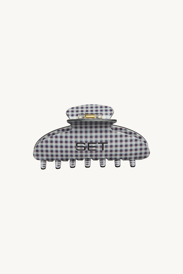 Checkered hair clip with 'SET' branding on a white background
