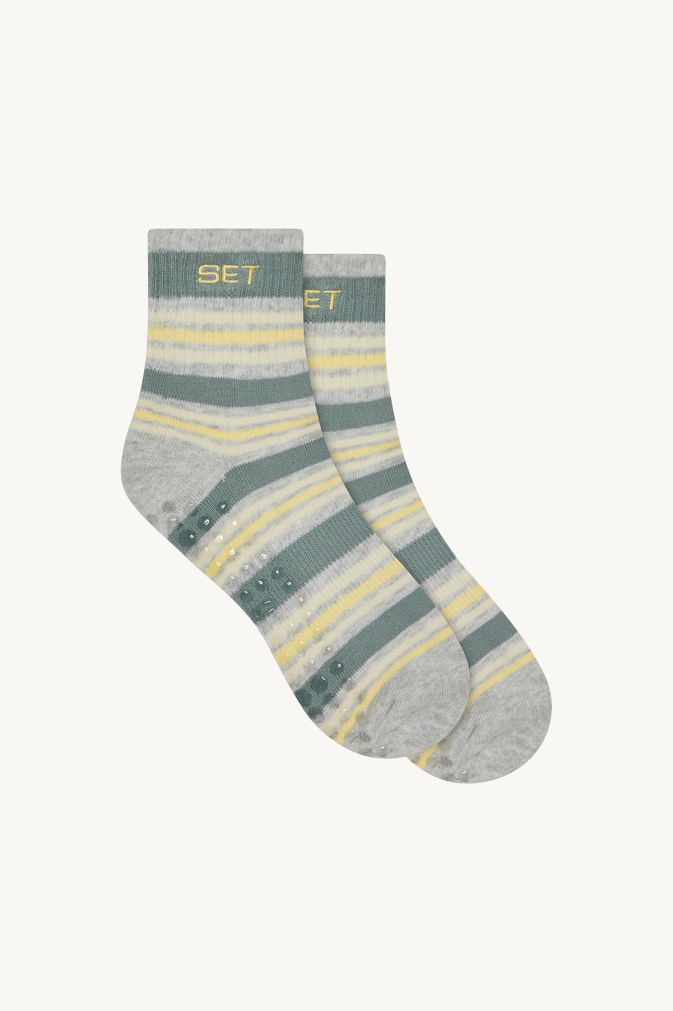 Striped socks with yellow and gray pattern on a white background