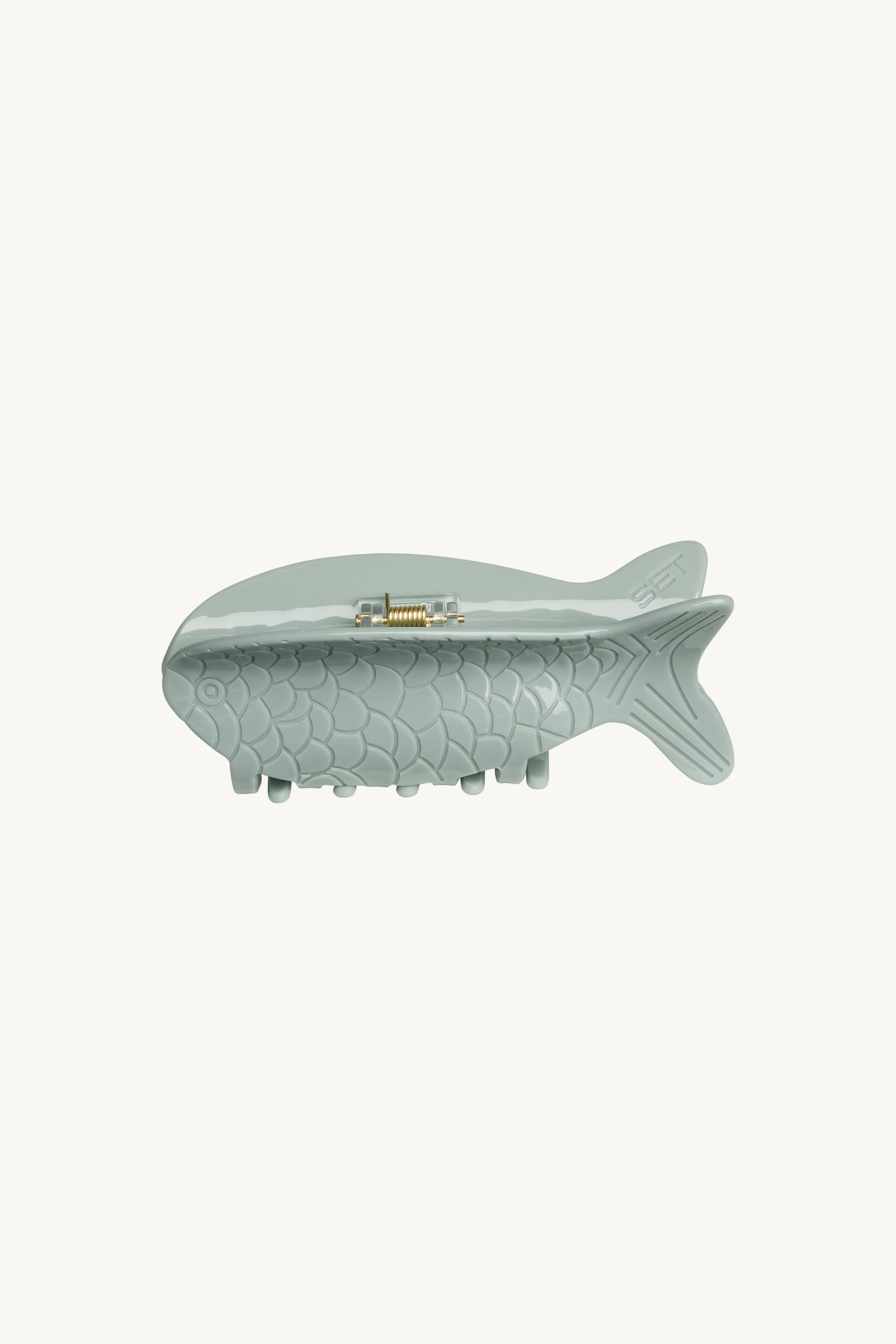 Fish-shaped claw clip on a white background