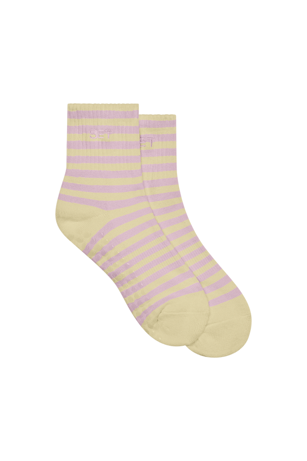 Pair of yellow and pink striped socks on a white background