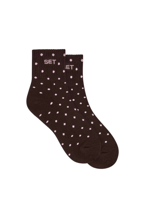 Brown sock with white polka dots on a white background
