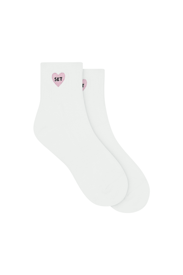 White socks with I LOVE SET pink heart design on a white background