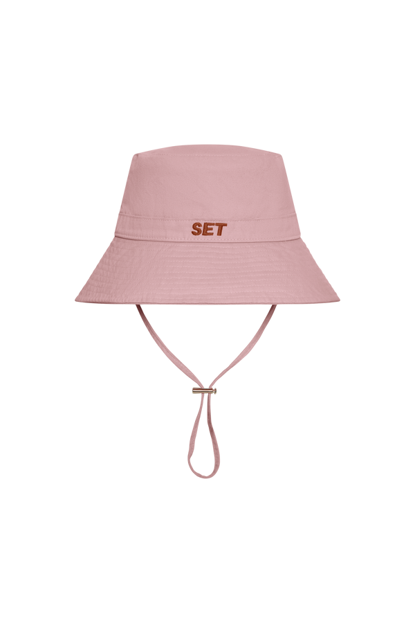 Pink bucket hat with 'SET' branding on a white background