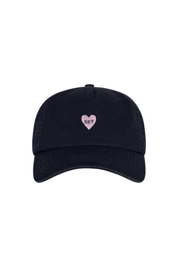 Black cap with a pink heart and 'SET' logo on a white background