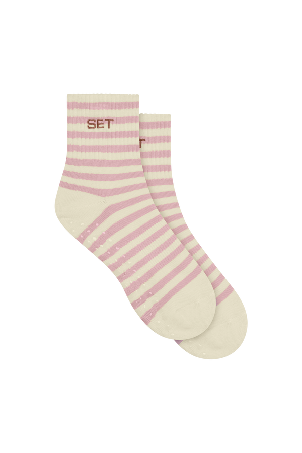 Pair of pink and white striped socks on a white background