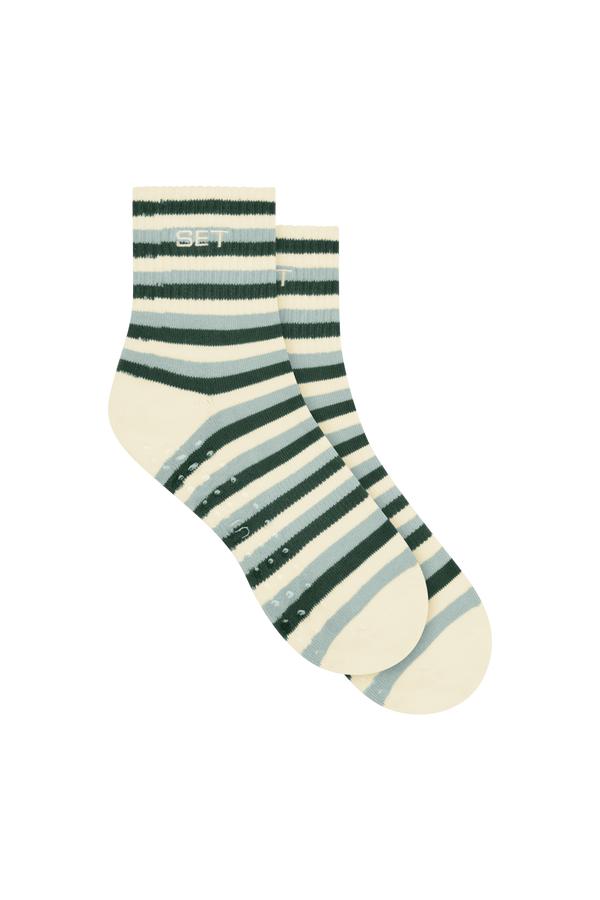 Striped sock with green and beige pattern on a white background