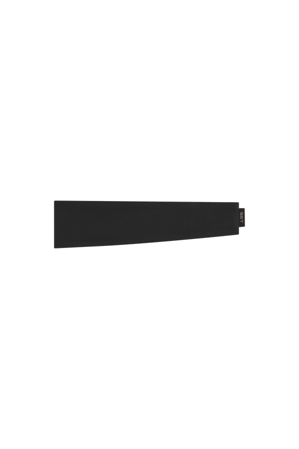 A minimalist black rectangular accessory with a small dark tag on the right end, photographed against a solid white background.