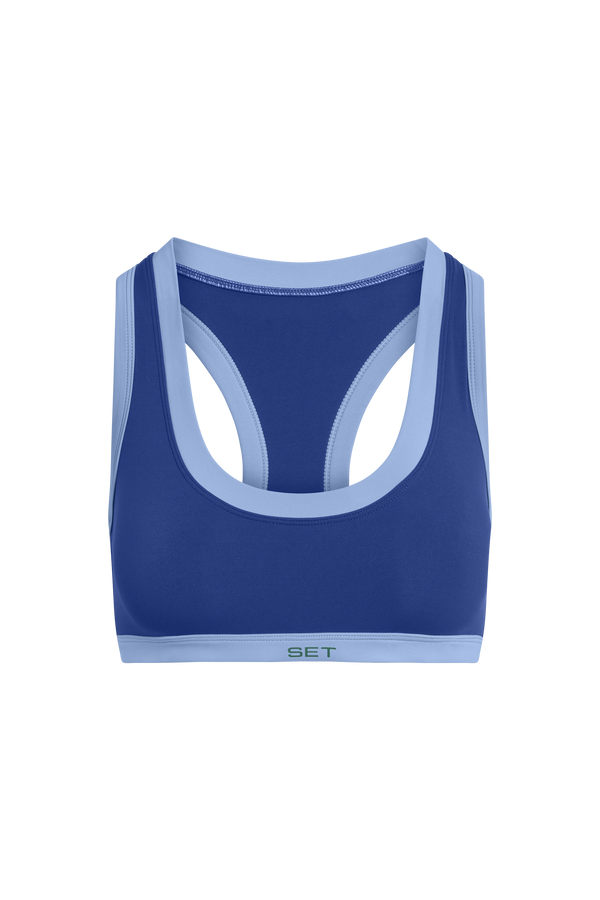 Blue sports bra with light blue straps on a white background