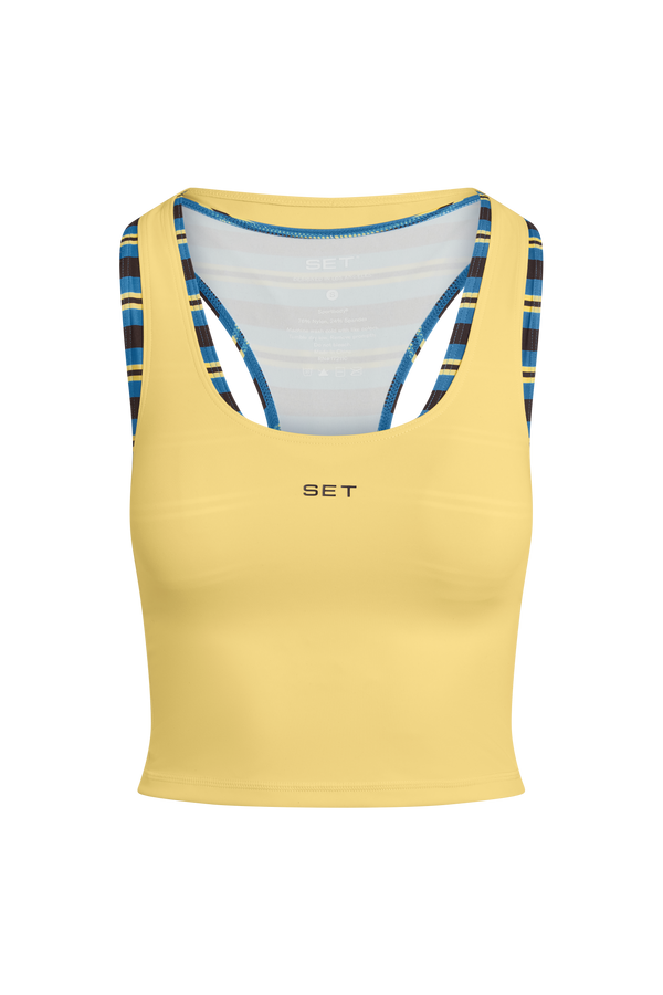 Yellow tank top with blue and black straps on a white background