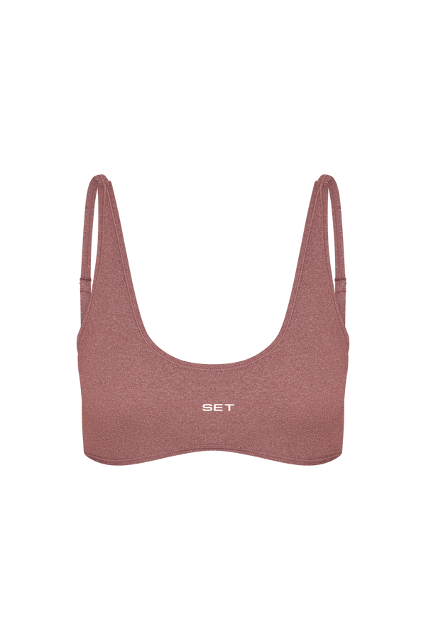 Pink sports bra with 'SET' branding on a white background