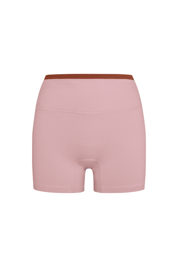 Pink shorts with a brown waistband on a white background
