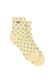 A pair of cream-colored ankle socks with a small dark brown polka dot pattern and the word 'SET' printed on the cuff, shown against a plain white background.