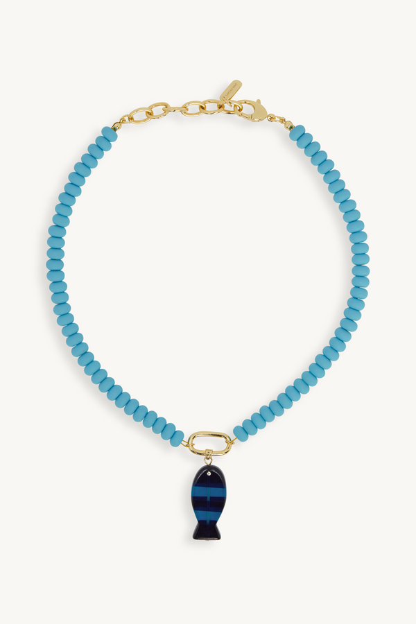 Blue beaded necklace with a fish-shaped pendant on a white background