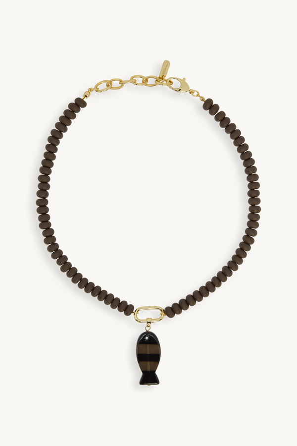 Necklace with brown beads and a black pendant on a white background